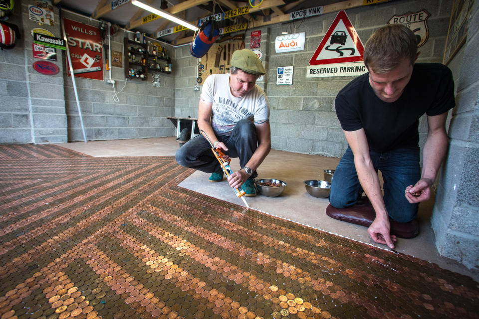 The coins are soaked in Coca-Cola to make them shine before being glued to the floor (Francis Hawkins/SWNS.com)