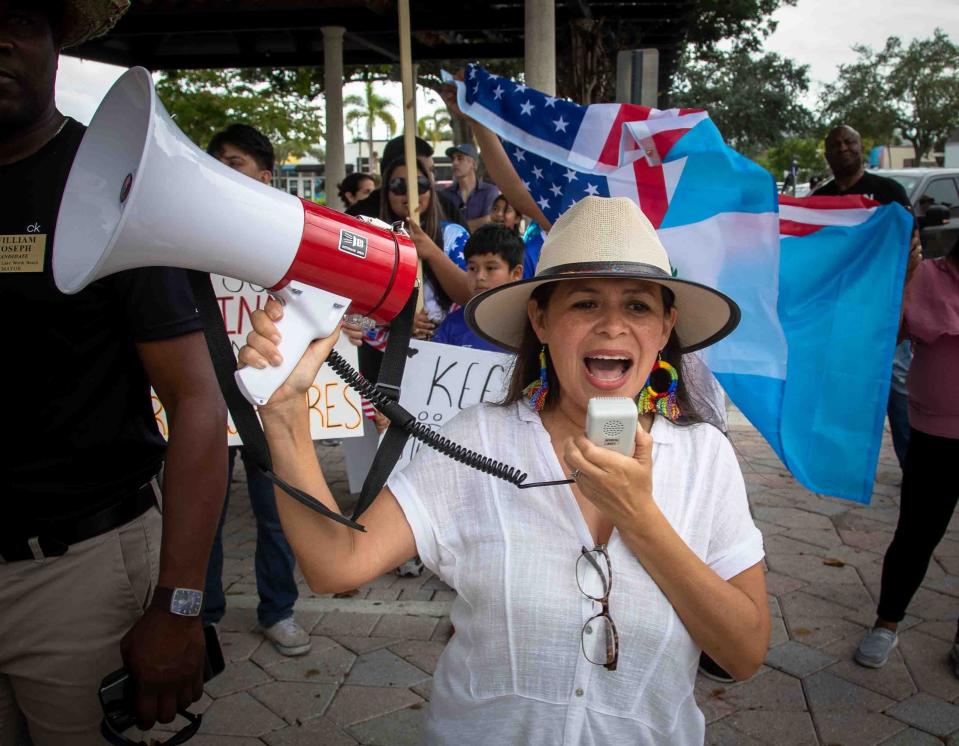 Karymn Salcedo makes remarks on a loud speaker during a rally in Lake Worth Beach to protest Florida's new (SB) 1718 immigration-related legislation June 25.