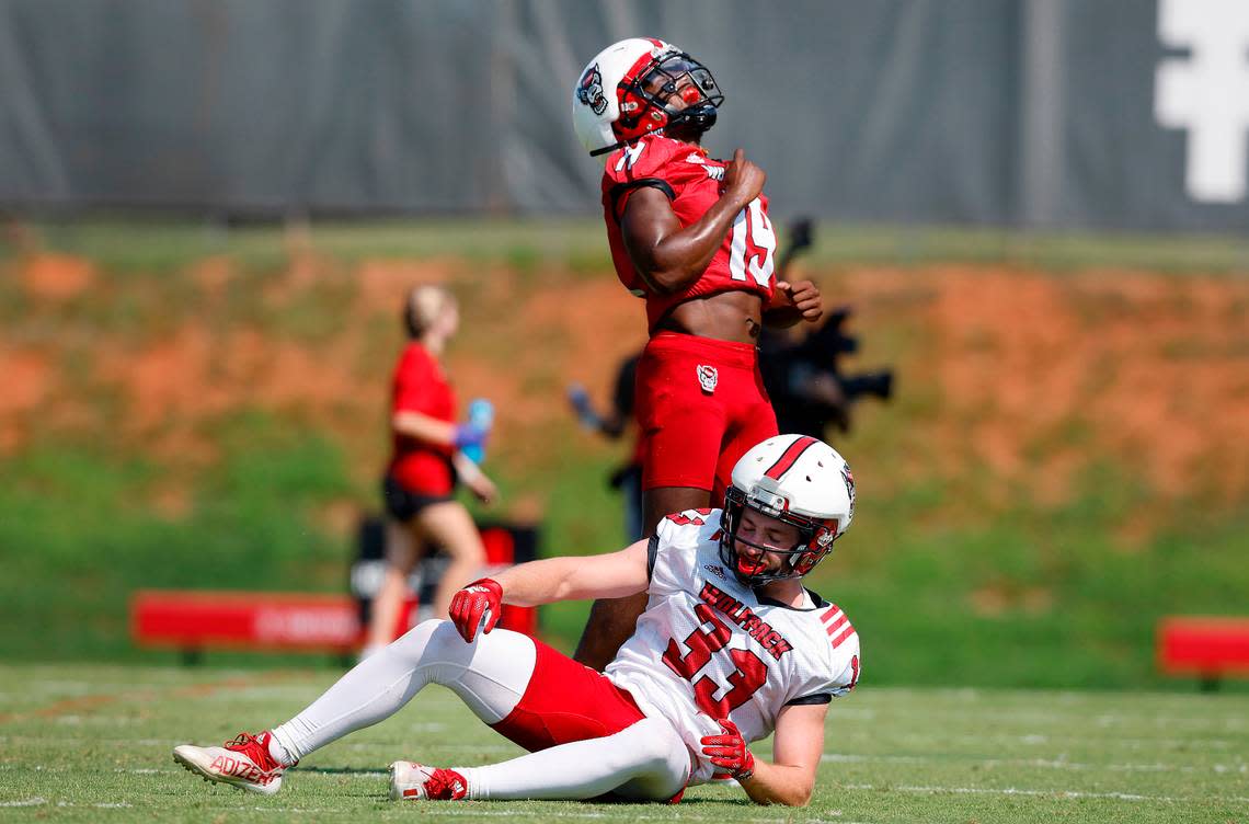 N.C. State cornerback Joshua Pierre-Louis (19) celebrates intercepting a pass intended for wide receiver Jackson DeSilva (33) during the Wolfpack’s first practice of fall camp in Raleigh, N.C., Wednesday, August 3, 2022.