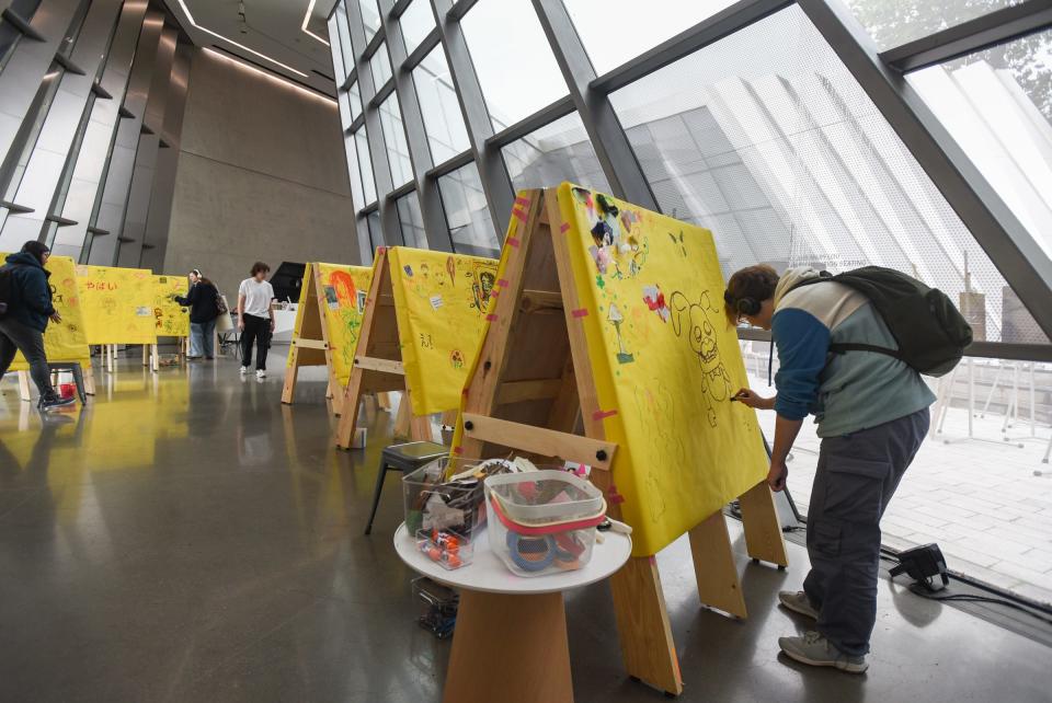 Michigan State freshman studio art major Campbell Stinson adds to a collaborative drawing, Thursday, Sept. 28, 2023, during the Broad's eight-hour Drawing Marathon at the Eli and Edythe Broad Art Museum in East Lansing.