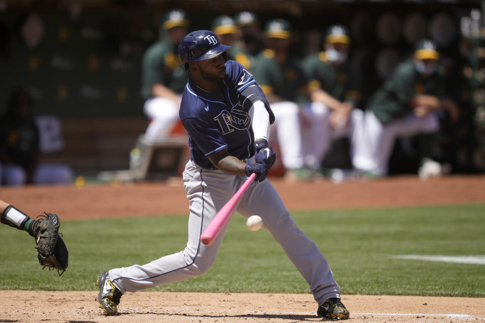 Tampa Bay Rays' Randy Arozarena hits a single against the Oakland Athletics during the third inning of a baseball game Saturday, May 8, 2021, in Oakland, Calif. (AP Photo/Tony Avelar)