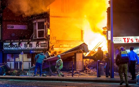 Dramatic pictures show flames erupting from the store on Hinckley Road, Leicester, after witnesses told of hearing a "massive explosion." - Credit: Jason Senior/SWNS.com