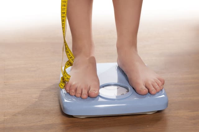 woman's legs on a domestic weight scale