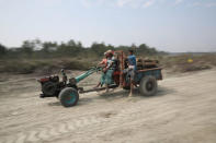 Workers carry trunks on a modified van in the Vashan Char, previously known as Thengar Char island in the Bay of Bengal, Bangladesh February 14, 2018. Picture taken February 14, 2018. REUTERS/Stringer