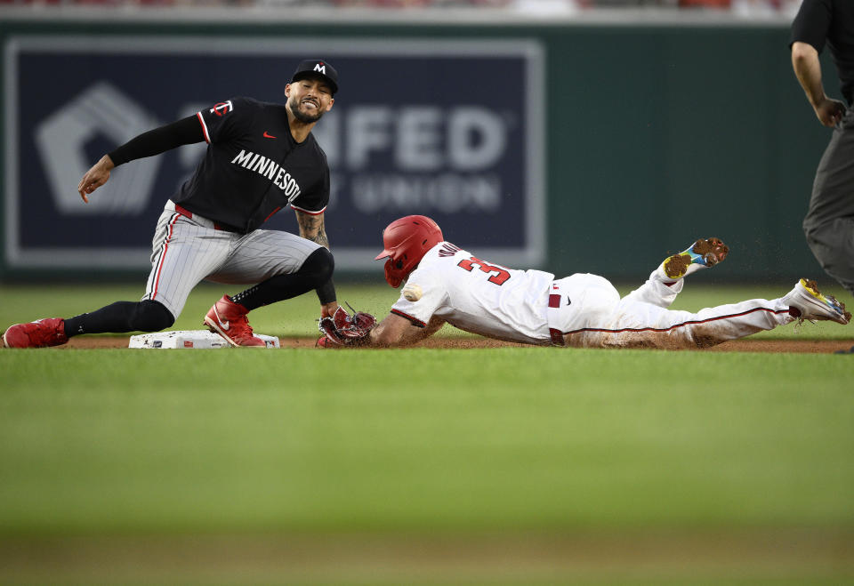 Washington Nationals' Jacob Young, right, steals second against Minnesota Twins shortstop Carlos Correa, left, during the fifth inning of a baseball game, Monday, May 20, 2024, in Washington. (AP Photo/Nick Wass)