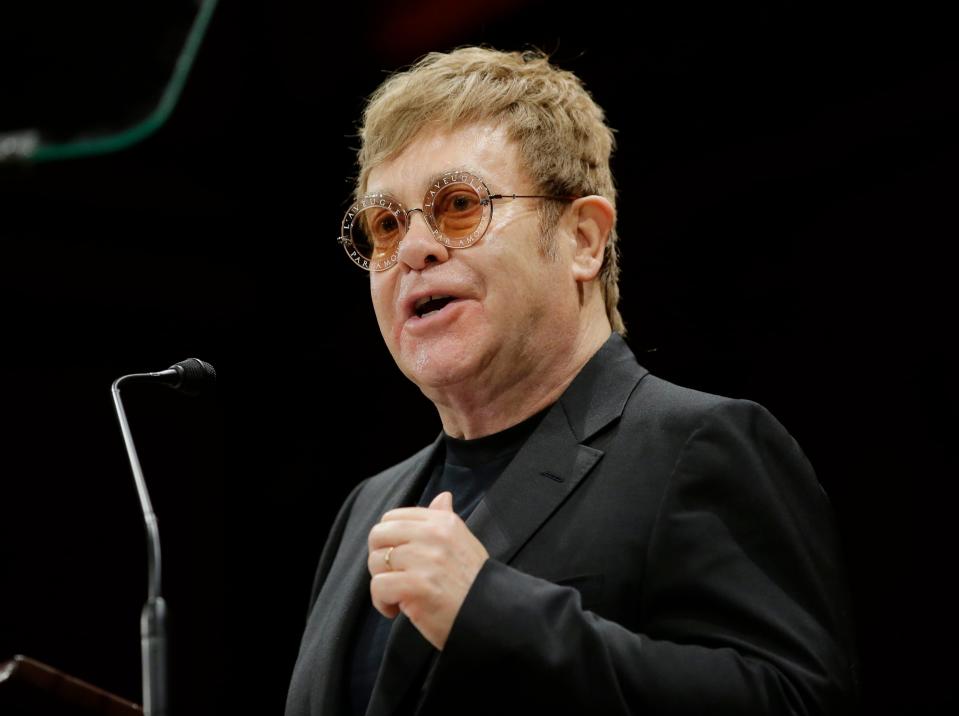 <p>Sir Elton addresses an audience before being presented with the 2017 Harvard Humanitarian of the Year Award</p> (AP)