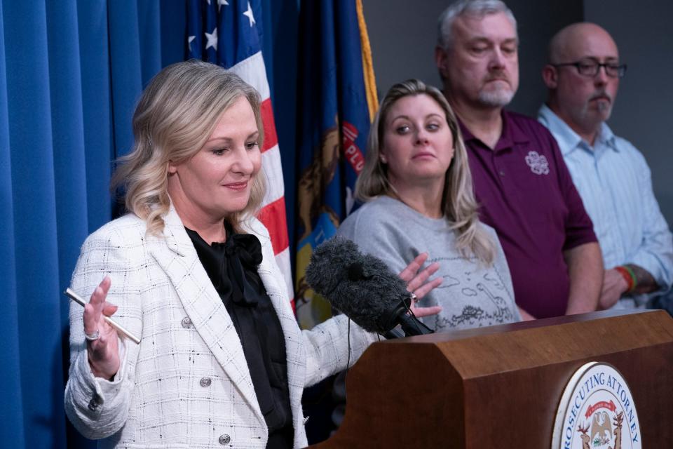 Oakland County Prosecutor Karen McDonald speaks to the media on Thursday as Nicole Beausoleil, mother of Madisyn Baldwin; Steve St. Juliana, father of Hana St. Juliana; and Craig Shilling, father of Justin Shilling, look on after James Crumbley was found guilty on four counts of involuntary manslaughter for the 2021 murders of four students at Oxford High School by Crumbley's son.