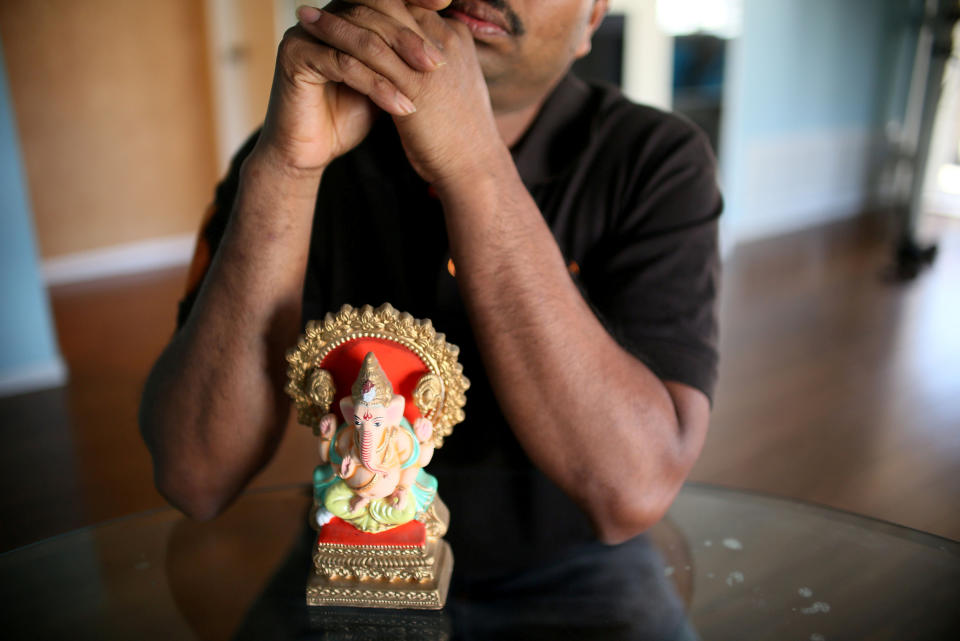 Raj, an immigrant from Sri Lanka, sits in his apartment in San Diego, California, U.S., April 9, 2017. Picture taken April 9, 2017. REUTERS/Sandy Huffaker