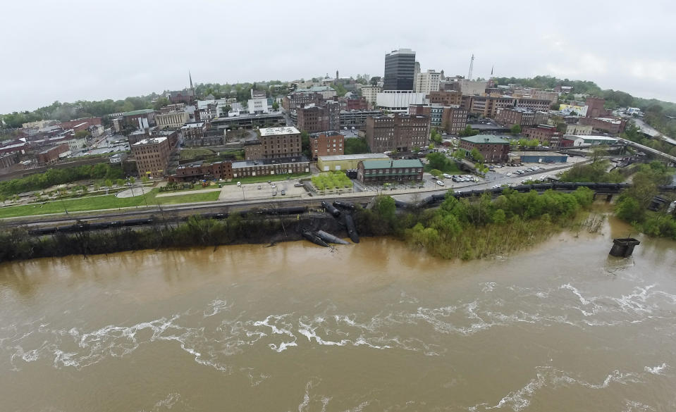 In this aerial photo taken with a drone, provided by Joshua Cruse & Kyle Hotchkiss, firefighters and rescue personnel work along the tracks where several CSX tanker cars carrying crude oil derailed and caught fire along the James River in Lynchburg, Va., Wednesday, April 30, 2014. (AP Photo/Joshua Cruse & Kyle Hotchkiss) MANDATORY CREDIT