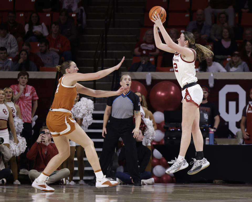 Oklahoma guard Payton Verhulst, right, shoots against Texas forward Taylor Jones during the first half of an NCAA college basketball game Wednesday, Feb. 28, 2024, in Norman, Okla. (AP Photo/Garett Fisbeck)