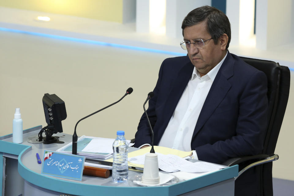 In this photo made available by the government-affiliated Young Journalists Club, presidential candidate Abdolnasser Hemmati attends a televised debate in a state-run television studio, in Tehran, Iran, on Saturday, June 5, 2021. Elections are scheduled for June 18. (Morteza Fakhri Nezhad/YJC via AP)