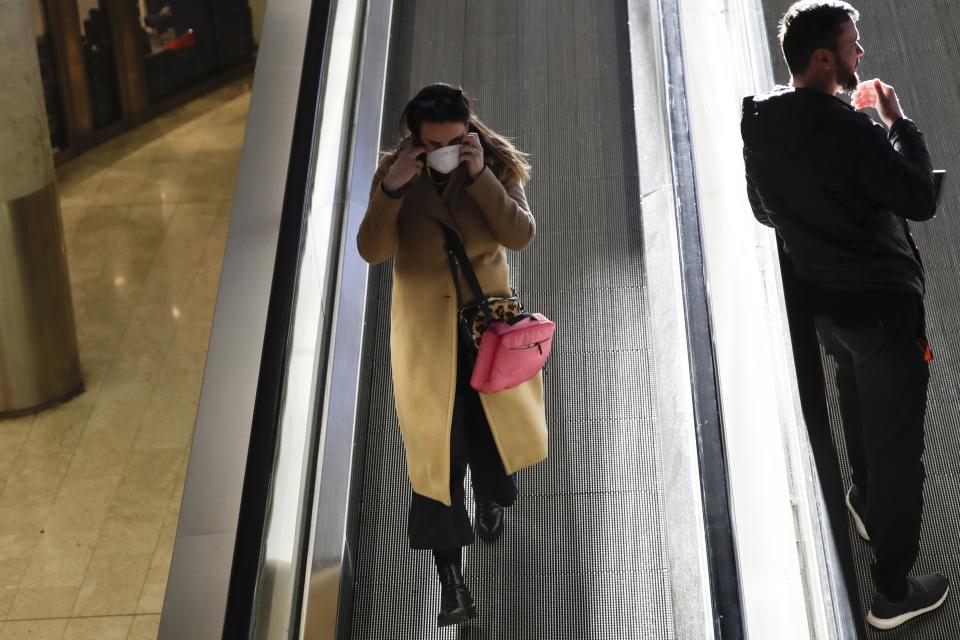 A woman wearing a sanitary mask walks at the Centrale main railway station in Milan, Italy, Monday, Feb. 24, 2020. Italy has been scrambling to check the spread of Europe's first major outbreak of the new viral disease amid rapidly rising numbers of infections and a third death, calling off the popular Venice Carnival, scrapping major league soccer matches in the stricken area and shuttering theaters, including Milan's legendary La Scala. (AP Photo/Luca Bruno)