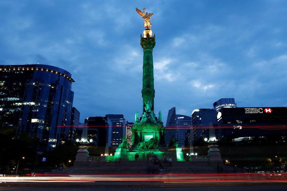 Green lights are projected at the Angel of Independence monument in Mexico City, Mexico.