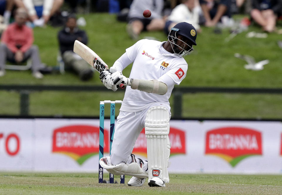 Sri Lanka's Angelo Mathews ducks to avoid a bouncer during play on day one of the second cricket test between New Zealand and Sri Lanka at Hagley Oval in Christchurch, New Zealand, Wednesday, Dec. 26, 2018. (AP Photo/Mark Baker)