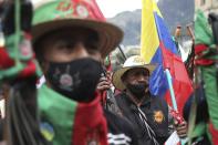 Members of the Indigenous Guard march against the government’s handling of a wide range of issues including the economic fallout of the pandemic and implementation of the peace accord, in Bogota, Colombia, Wednesday, Oct. 21, 2020. Indigenous leaders, students and union members gathered in Plaza Bolivar waving flags and banners decrying the government nearly one year after massive protests rocked the country only to fizzle with little to show by way of reform. (AP Photo/Fernando Vergara)