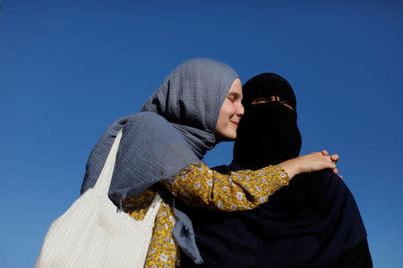 Natacha (L), 21, and Nayab, 18, both members of the group Kvinder I Dialog (Women In Dialogue), stand together on a playground in Copenhagen, Denmark, July 20, 2018. REUTERS/Andrew Kelly