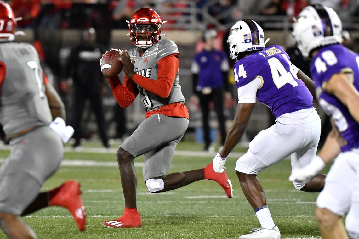 Louisville quarterback Malik Cunningham (3) runs from the pursuit of James Madison linebacker Taurus Jones (44) as he drops back to pass during the first half of an NCAA college football game in Louisville, Ky., Saturday, Nov. 5, 2022. (AP Photo/Timothy D. Easley)