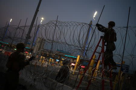 United States Marines fortify concertina wire along the San Ysidro Port of Entry border crossing as seen from Tijuana, Mexico November 20, 2018. REUTERS/Adrees Latif