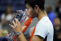 Carlos Alcaraz, of Spain, kisses the championship trophy after defeating Casper Ruud, of Norway, in the men's singles final of the U.S. Open tennis championships, Sunday, Sept. 11, 2022, in New York. (AP Photo/John Minchillo)