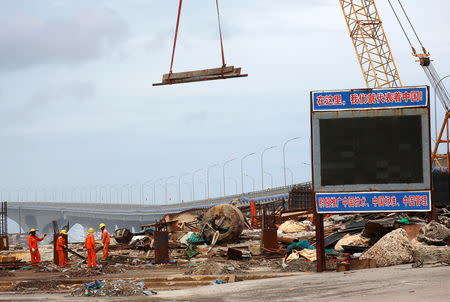 FILE PHOTO: Constrcution workers work at a site as the China-funded Sinamale bridge is seen in Male, Maldives September 18, 2018. REUTERS/Ashwa Faheem/File Photo