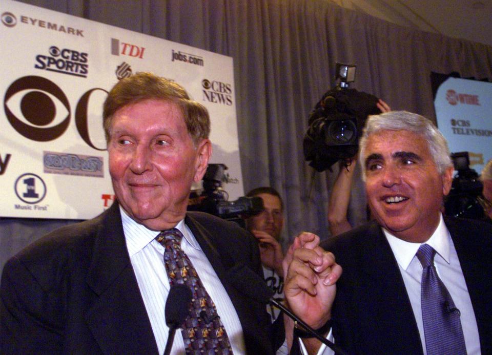 Sumner Redstone, left, chairman and CEO of Viacom Inc., grasps hands with  Mel Karmazin, president and CEO of CBS Corp., after a merger was announced between the two companies Tuesday Sept. 7, 1999. Viacom Inc., the owner of MTV and Paramount studios, is buying CBS Corp. for $36.75 billion, making the richest media merger in history. (AP Photo/Suzanne Plunkett)