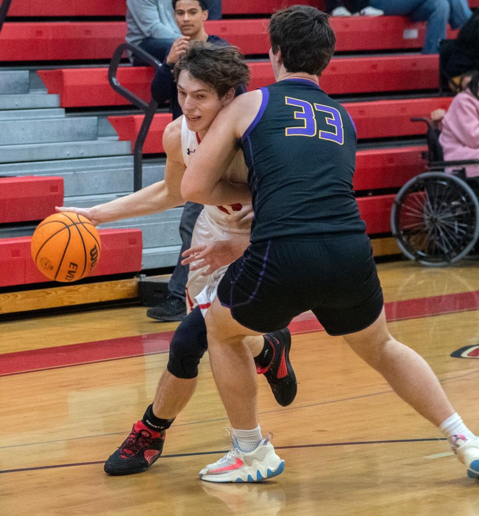Ripon's Marcus Madoski, left, drives on Escalon's Ryan Lewis during a Sac-Joaquin Section Division 4 boys basketball quarterfinal playoff game at Ripon High on Feb. 15, 2024.