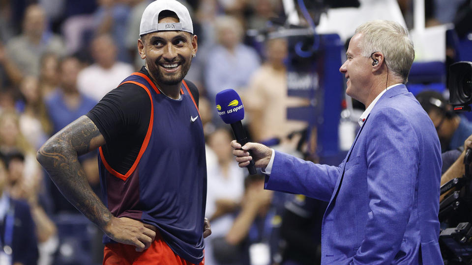 Nick Kyrgios smiles at the crowd during his post-match interview after defeating Daniil Medvedev. 