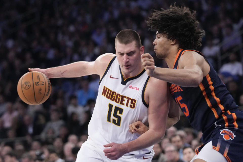 Denver Nuggets center Nikola Jokic (15) drives against New York Knicks center Jericho Sims, right, in the first half of an NBA basketball game, Thursday, Jan. 25, 2024, at Madison Square Garden in New York. (AP Photo/Mary Altaffer)