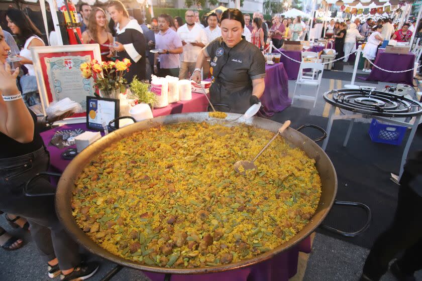 Natalie Curie from El Coraloence restaurant serves her award winning paella during AltaMed Health Services hosts East LA Meets Napa Food & Wine Festival 2022 at La Live in Downtown Los Angeles on Friday, July 29, 2022. Patrons enjoyed food tastings from top 15 Latino-owned Los Angeles restaurants complimented with wine and spirit pairings from 15 fames Napa Valley vintners. (Photo by James Carbone)