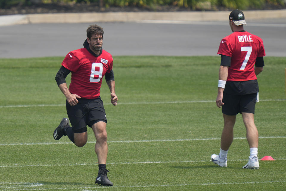 New York Jets quarterback Aaron Rodgers, left, warms up at the NFL football team's training facility in Florham Park, N.J., Tuesday, June 6, 2023. (AP Photo/Seth Wenig)