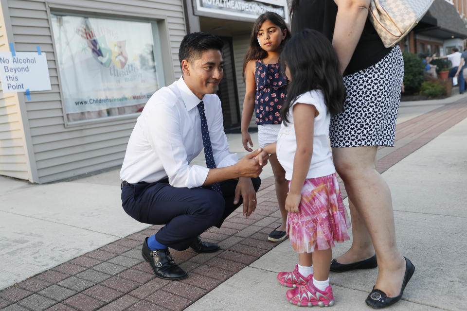 Hamilton County Clerk of Courts Aftab Pureval greets constituents and their children as he campaigns for his challenge against Republican Rep. Steve Chabot at a music festival in Mason, Ohio, June 15, 2018. (AP Photo/John Minchillo)