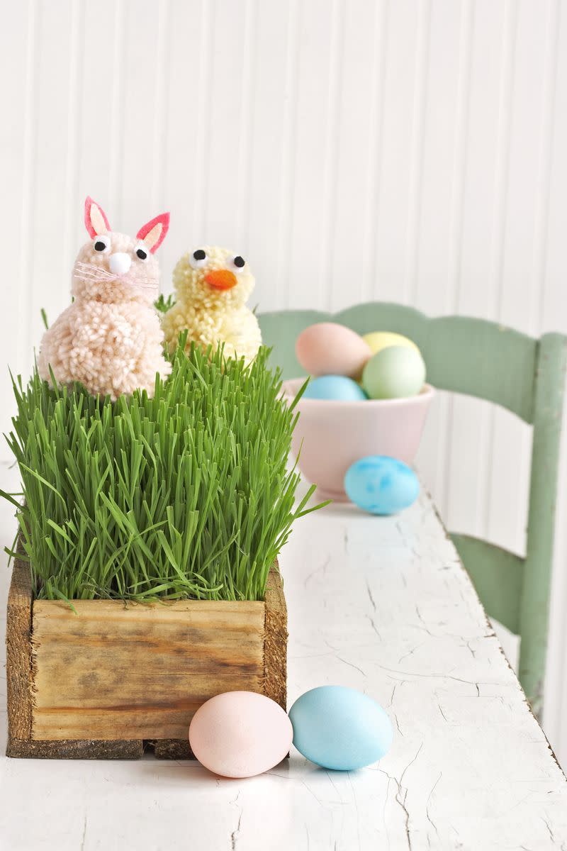 pom pom bunny and chick in easter grass on table