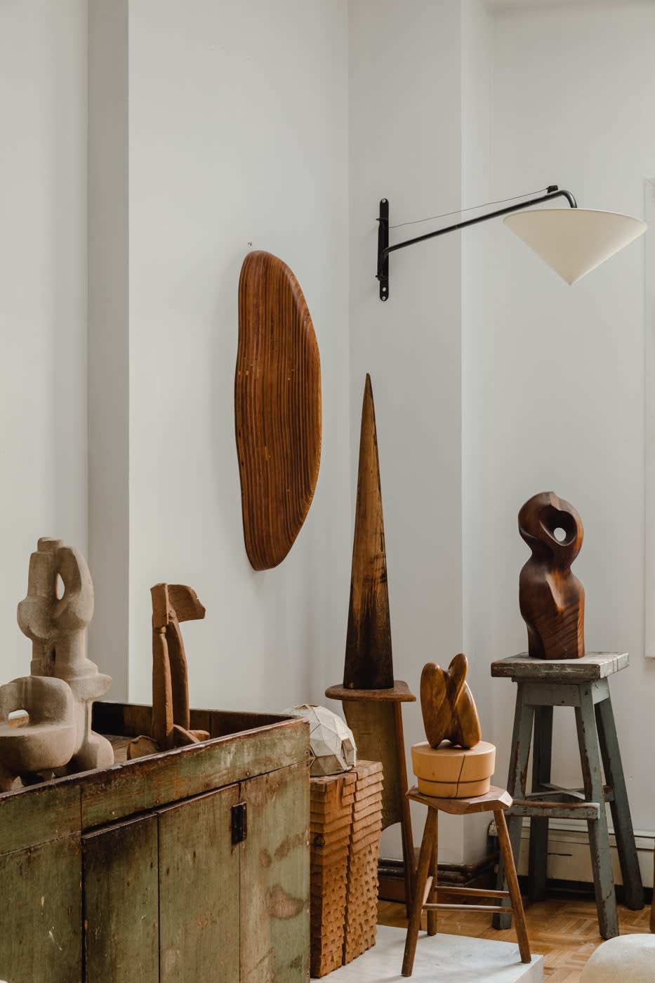 Jonny opted to hang a 1970s stack-laminated wood shelf vertically so it looked a little more interesting. It is shown here with a collection of wooden stools, objects, and sculptures, many of them with makers unknown. That doesn’t bother Jonny.  “I love anonymous, unattributed objects and pieces,” he says. “What I always ask is, Where else are you going to find it? You’re just not.”