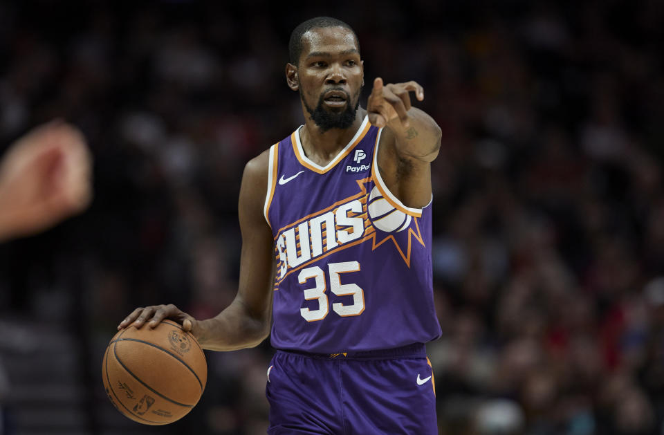Phoenix Suns forward Kevin Durant points as he brings the ball up against the Portland Trail Blazers during the first half of an NBA preseason basketball game in Portland, Ore., Thursday, Oct. 12, 2023. (AP Photo/Craig Mitchelldyer)