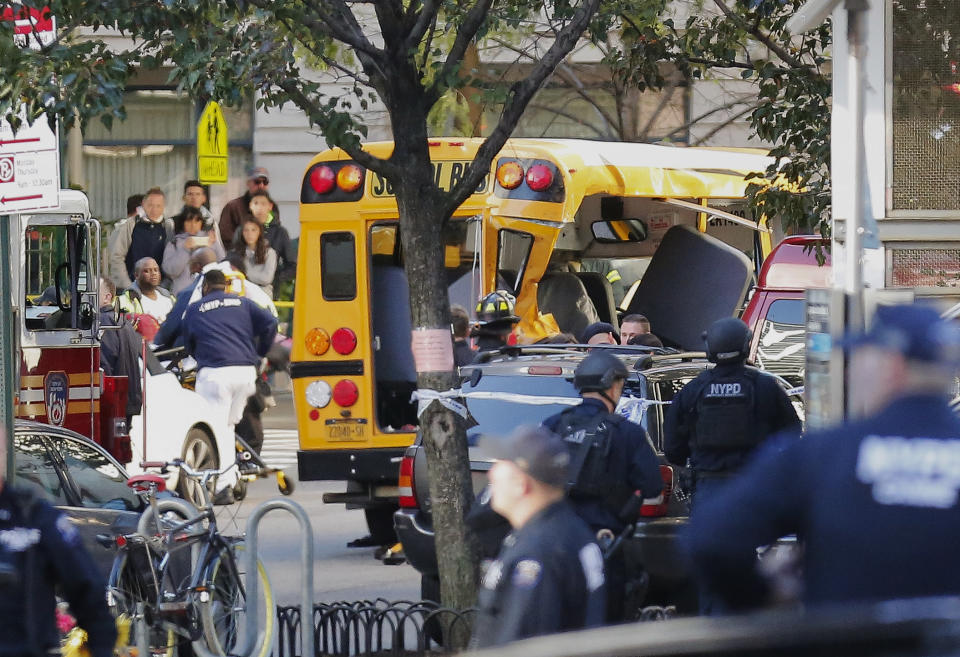 <p>Authorities respond near a damaged school bus on Oct. 31, 2017, in New York. A motorist drove onto a busy bicycle path near the World Trade Center memorial and struck several people on Tuesday police and witnesses said. (Photo: Bebeto Matthews/AP) </p>