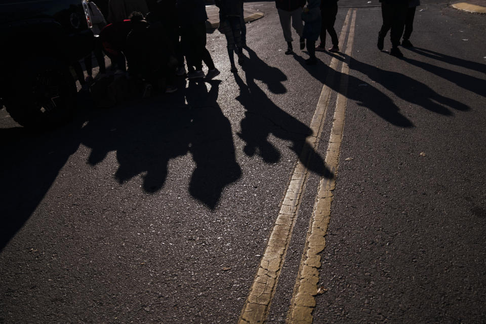 Migrants wait in line for food donations outside the Greyhound bus station near the U.S.-Mexico border in El Paso, Texas, on Dec. 21, 2022. (Eric Thayer / Bloomberg via Getty Images file)