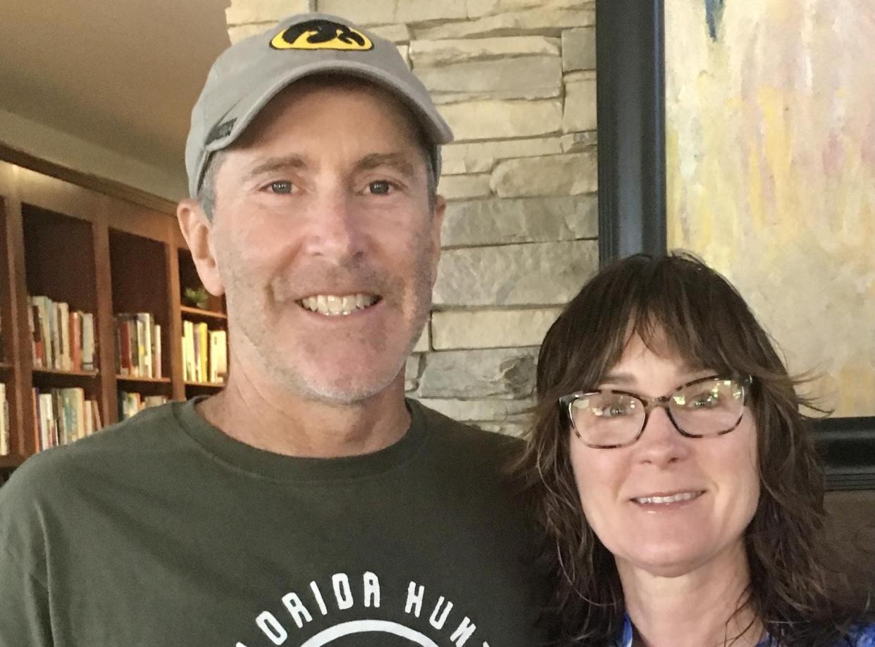 Tim and Carlotta Saylor pose at Vintage Co-op in Coralville, where his mother lives. After a day of birdwatching, he visited with his mother, Dixie, and her friends who were charmed by his storytelling about his extensive travel for his TV series.