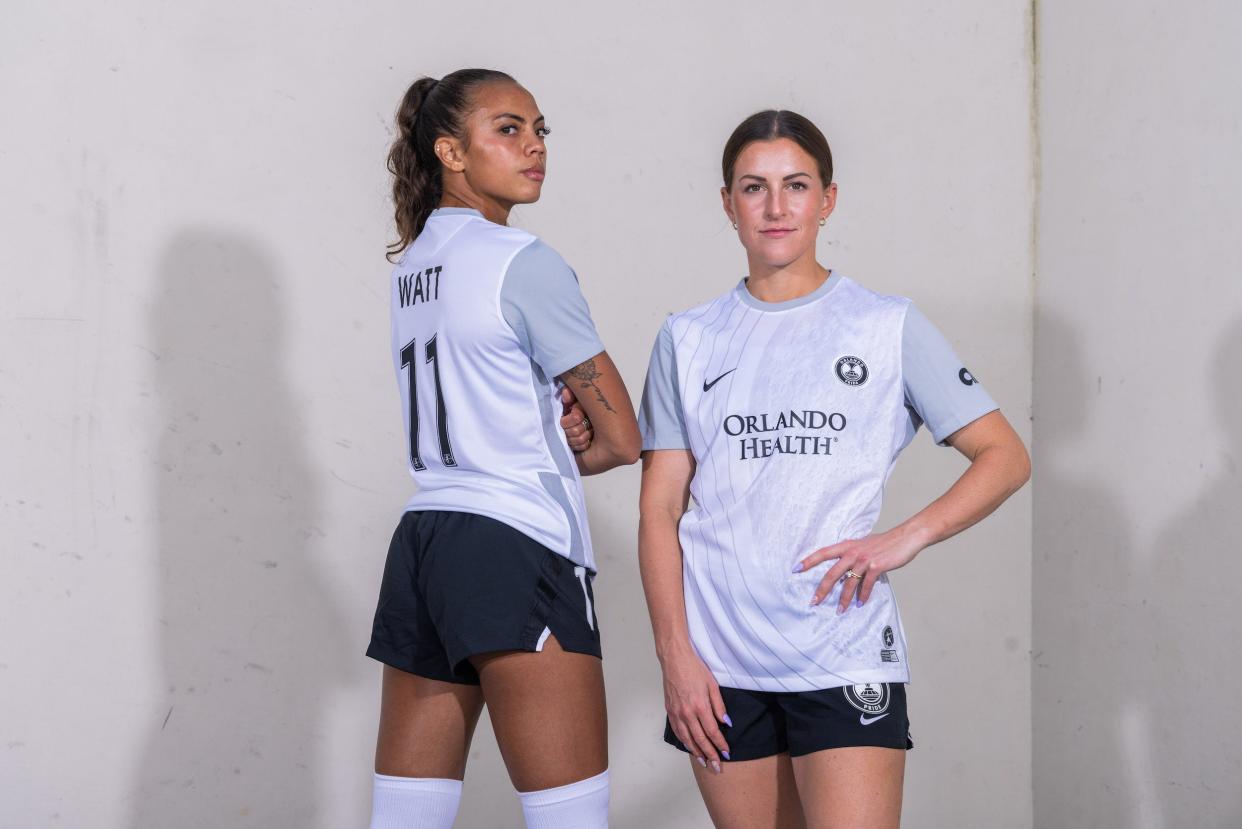 Orlando Pride players Ally Watt (left) and Haley McCutcheon pose in the club's 2023 Luna kits.