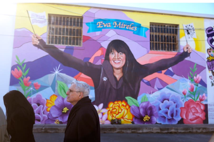 Attorney General Merrick Garland, right, and Associate Attorney General Vanita Gupta, left, tour murals of shooting victims, Wednesday, Jan. 17, 2024, in Uvalde, Texas. The Justice Department is planning this week to release findings of an investigation into the 2022 school shooting. (AP Photo/Eric Gay)