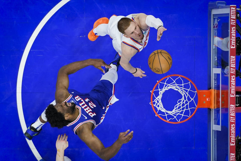 New York Knicks' Donte DiVincenzo, right, goes up to shoot against Philadelphia 76ers' Joel Embiid, left, during the second half of Game 6 in an NBA basketball first-round playoff series, Thursday, May 2, 2024, in Philadelphia. (AP Photo/Matt Slocum)