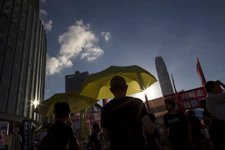 Pro-democracy protesters hold yellow umbrellas, symbol of the Occupy Central movement, during a demonstration outside Legislative Council in Hong Kong, China June 17, 2015. REUTERS/Tyrone Siu