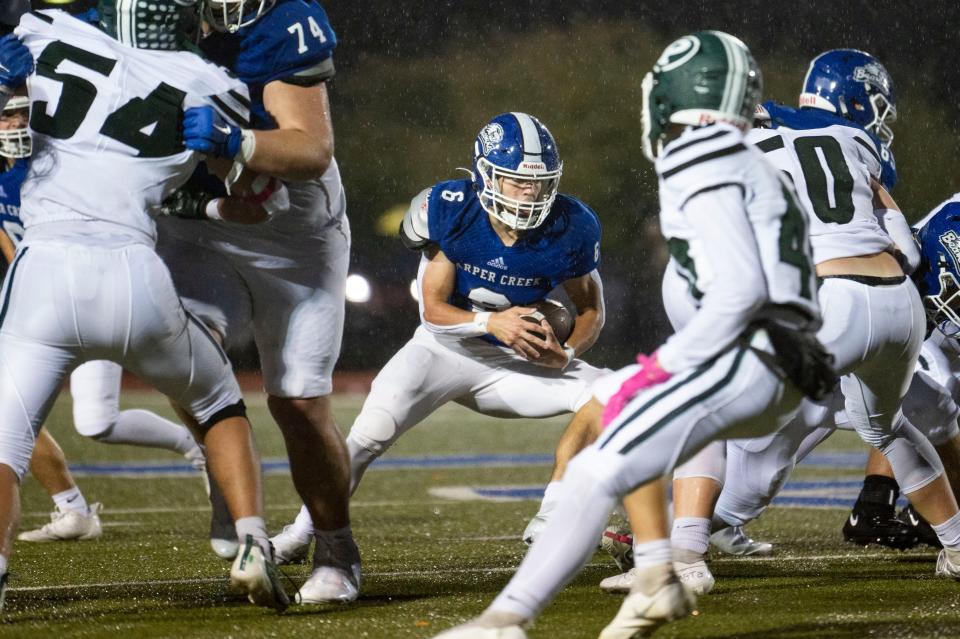 Harper Creek senior Bronson Carpenter receives the ball during a game against Pennfield at Harper Creek High School on Friday, Oct. 6, 2023.