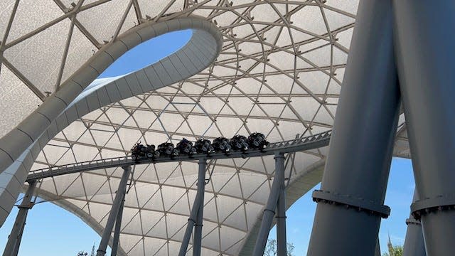 TRON Lightcycle / Run launches guests outside, under a massive canopy, which lights up at night.