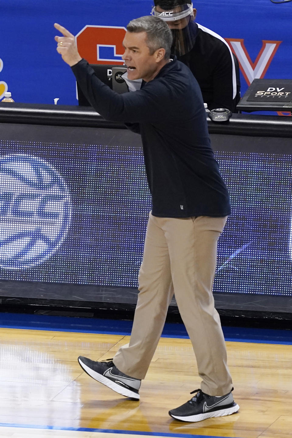 Virginia head coach Tony Bennett directs his team during the second half of an NCAA college basketball game against Syracuse in the quarterfinal round of the Atlantic Coast Conference tournament in Greensboro, N.C., Thursday, March 11, 2021. (AP Photo/Gerry Broome)