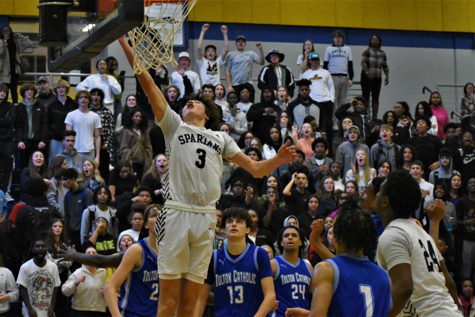 Battle forward Tate McCubbin (3) drives through the Father Tolton defense to the basket during a 63-51 win over the Trailblazers on January 18, 2023, in Columbia, Mo.