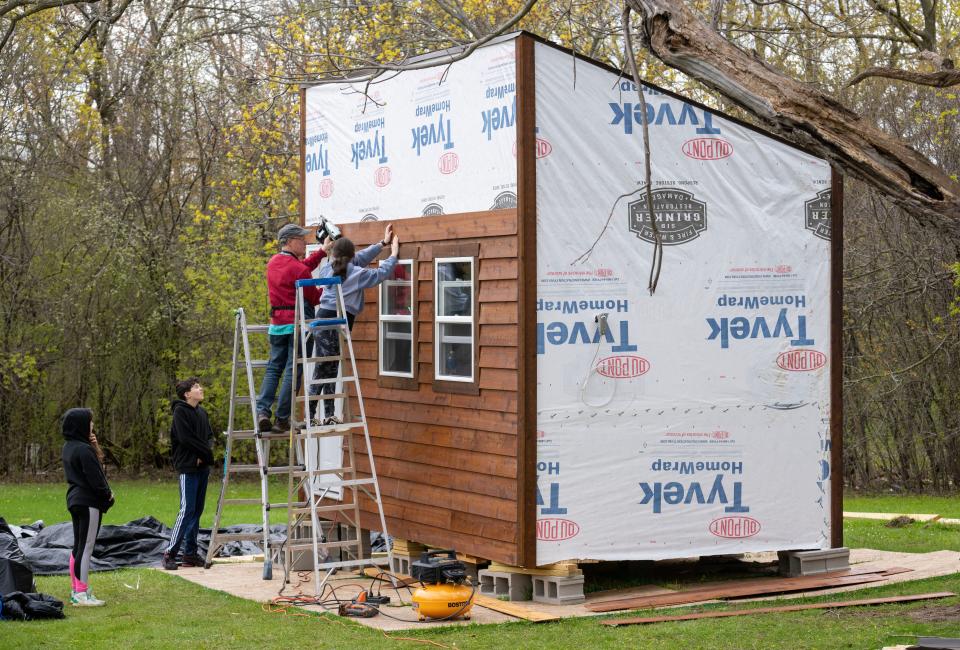 Students work with adjunct instructor Jim Salinsky on May 2 on a tiny house they're building at Milwaukee Jewish Day School in Whitefish Bay. Sixth through eighth grade woodworking students are constructing the 128-square-foot house, which will be moved to Racine at the end of the school year to house veterans.