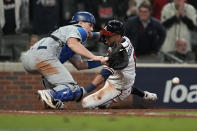 Los Angeles Dodgers catcher Will Smith can not make the tag on Atlanta Braves' Eddie Rosario scores on a single by Ozzie Albies in the eighth inning in Game 2 of baseball's National League Championship Series Sunday, Oct. 17, 2021, in Atlanta. (AP Photo/Ashley Landis)