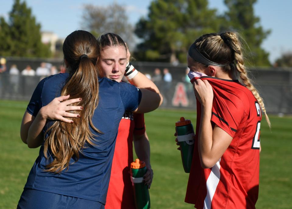 Texas Tech's midfielder Alex Kerr, center, embraces her teammates after the team's loss against North Carolina in the Sweet 16 round of the NCAA soccer tournament, Sunday, Nov. 19, 2023, at John Walker Soccer Complex.