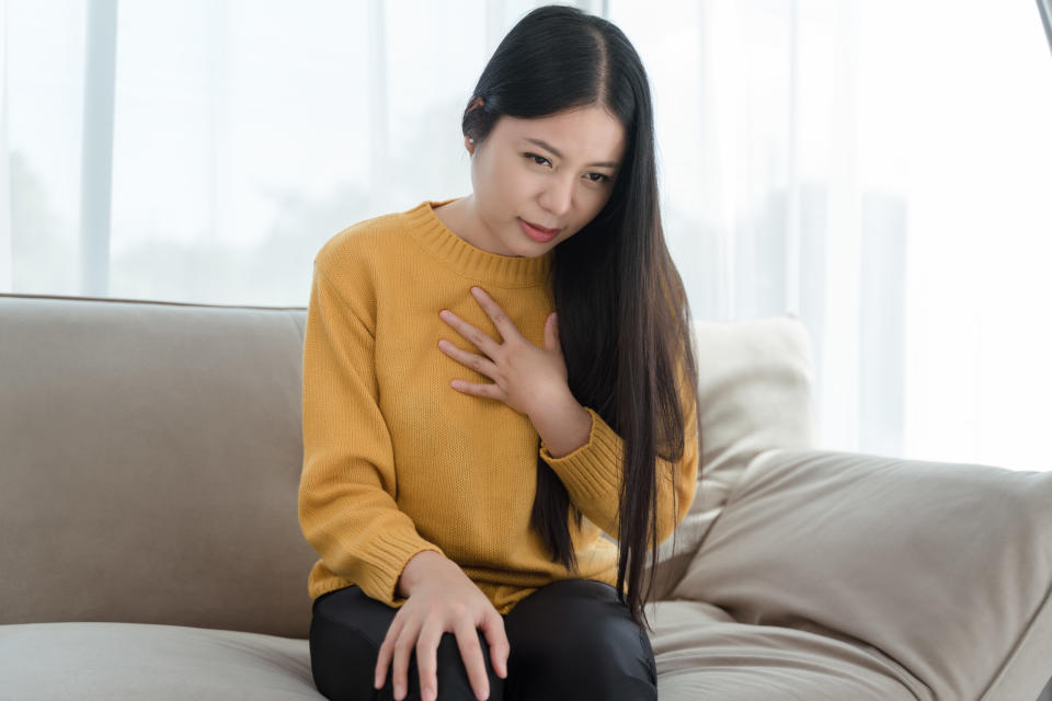 a woman touching her chest