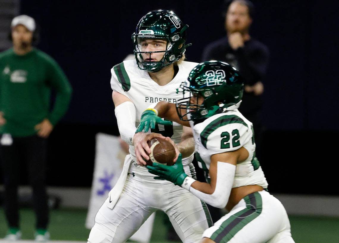 Prosper quarterback Nathan TenBarge (0) pulls the ball back from running back Leo Anguiano (22) for a pass attempt in the first half of a UIL Class 6A Division 1 football regional-round playoff game at The Ford Center in Frisco, Texas, Saturday, Oct. 25, 2023. North Crowley led Prosper 28-7 at the half.